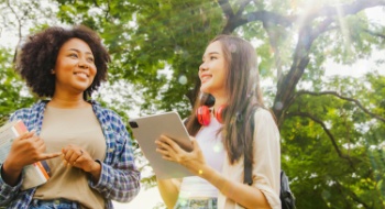 two young girls smile on a school field trip