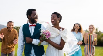 a bride and groom surrounded by their bridesmaids and groomsmen