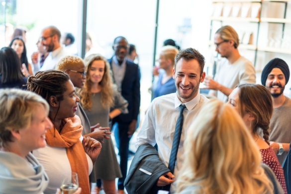 a large and diverse group of business professionals attend a networking event